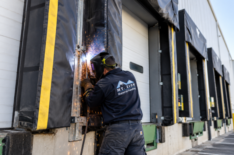 Technician repairing a commercial dock shelter frame